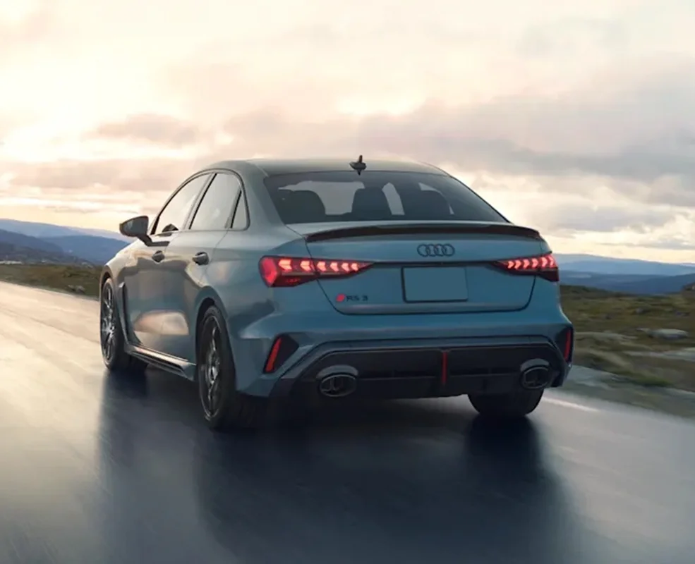back view of a gray 2026 Audi RS 3 driving on a road