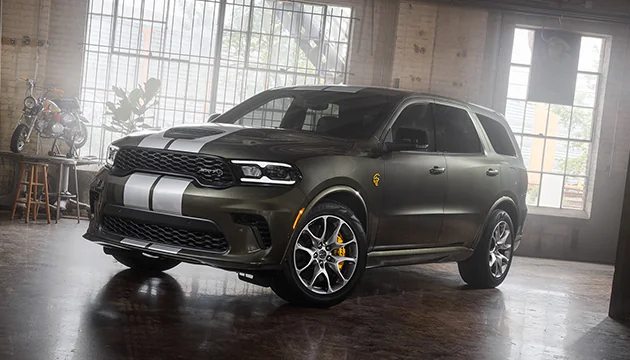 Front side view of a parked gray Dodge Durango in a workshop
