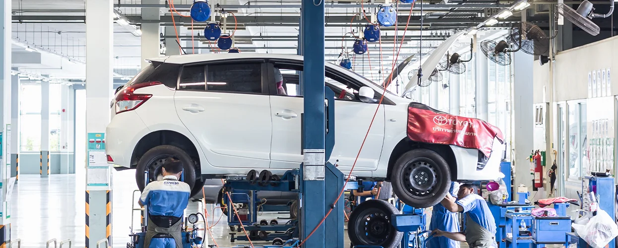 White Toyota SUV on a service lift
