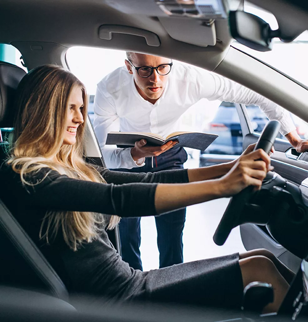 Car salesman shwoing a customer a new vehicle