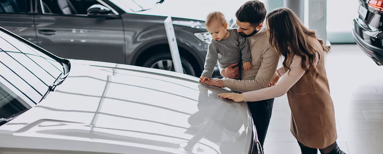 Family looking at a new vehicle in a Land Rover dealership