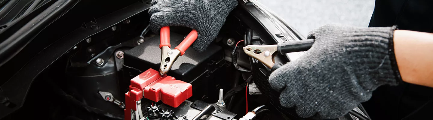 Mechanic using jumper cables on a car