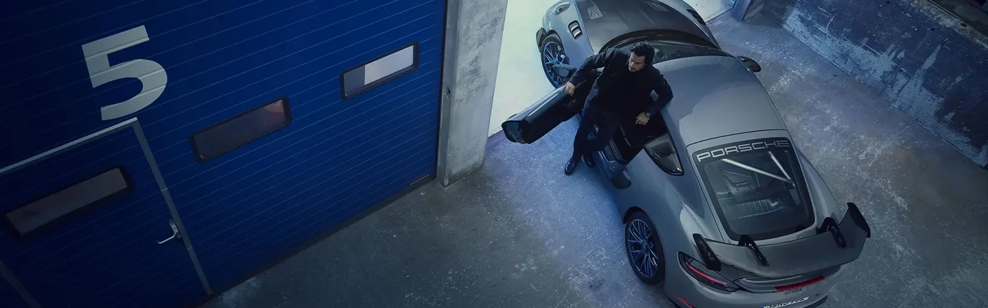 Top view of a 2024 Porsche Cayman GT4 parked out side of a garage