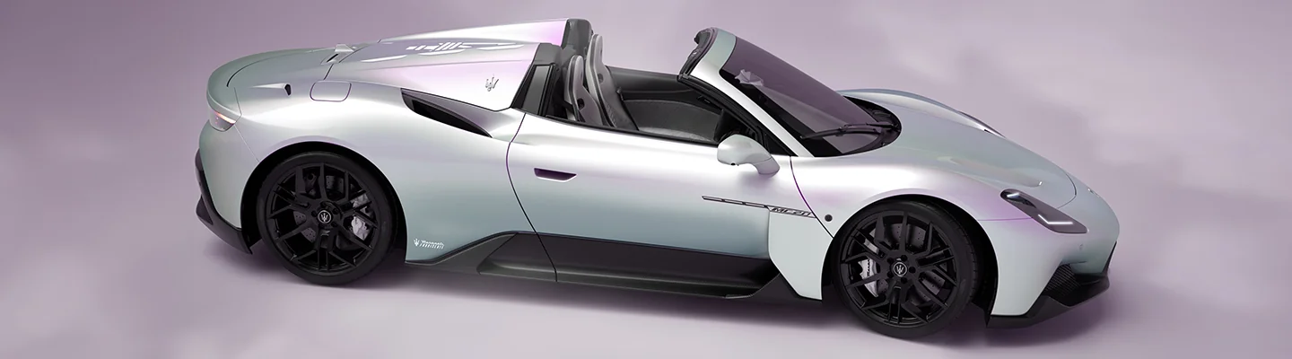 A gray Maserati GranCabrio parked in a studio setting