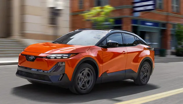 flashy orange bran new Subaru tearing up the town