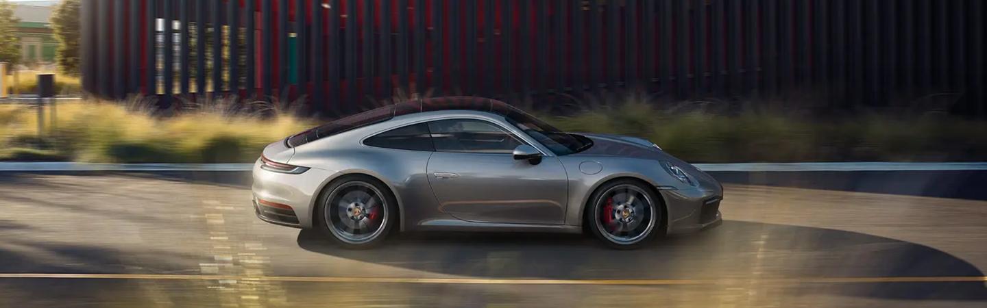 A silver 2021 Porsche 911 in motion