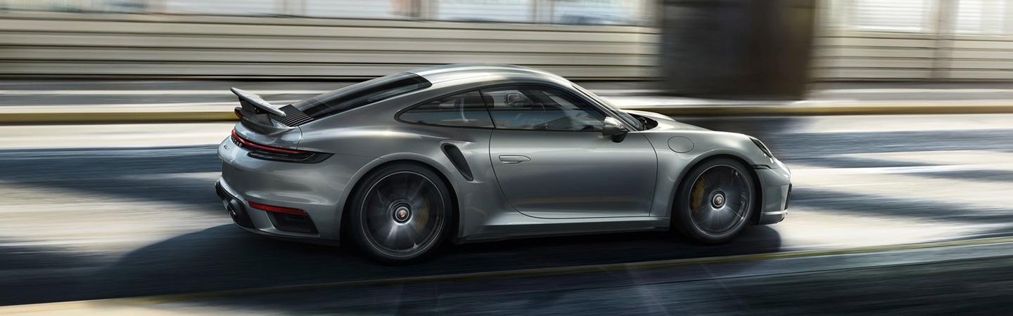 A side view of a silver 2021 Porsche 911 in motion