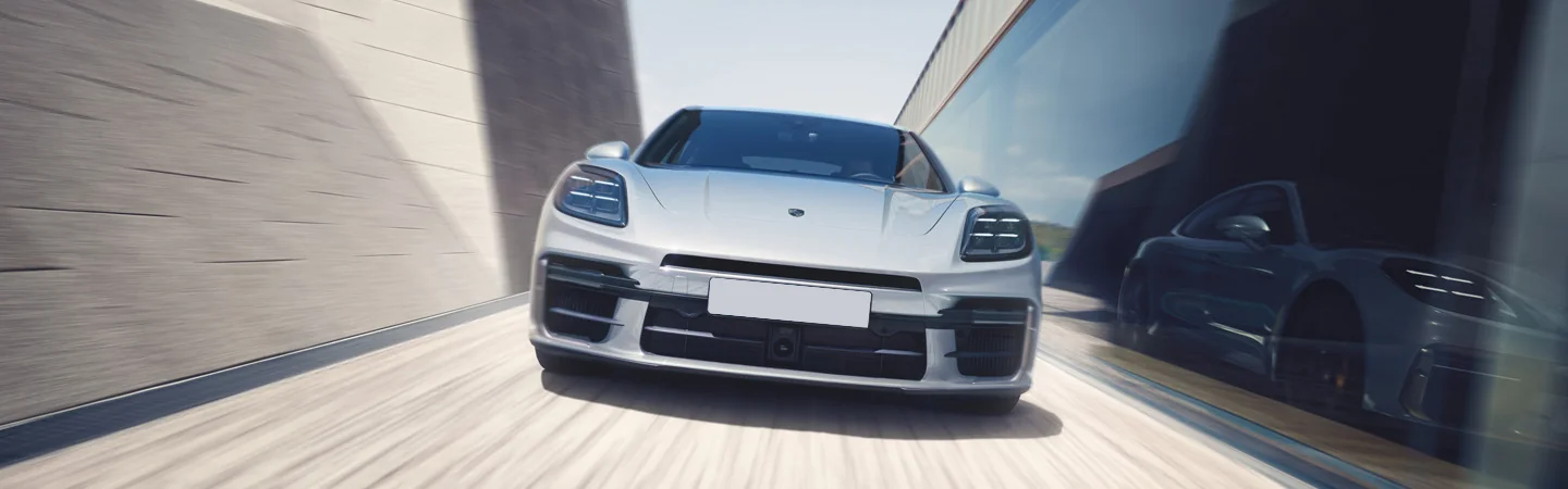 Front view of the 2025 Porsche Panamera driving through a tunnel