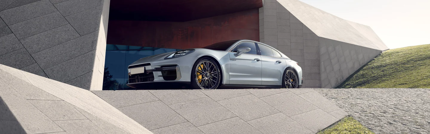 Side view of the 2025 Porsche Panamera parked in front of a building