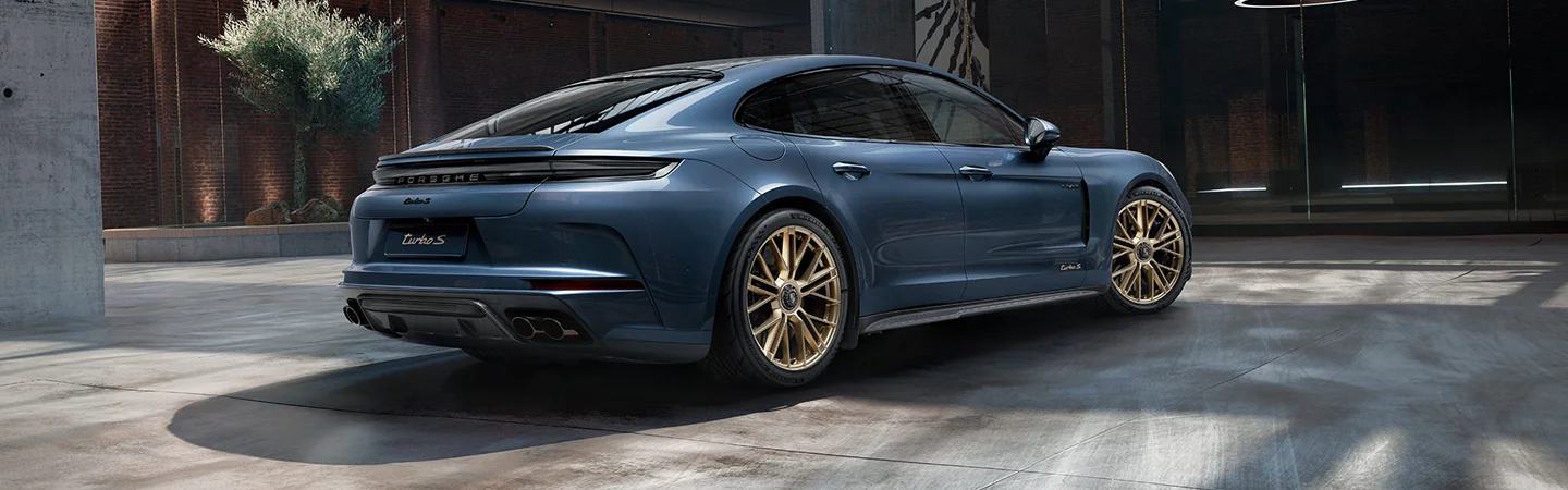 Rear view of the 2025 Porsche Panamera parked in front of a building
