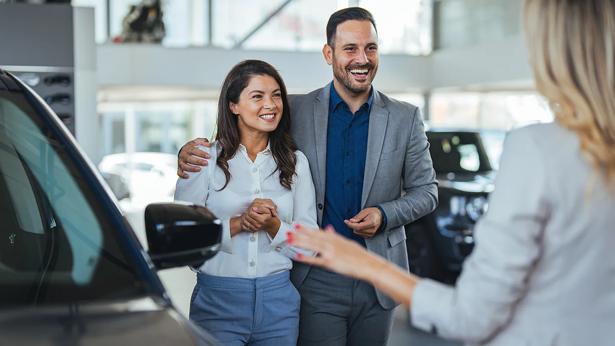 people in car showroom shopping
