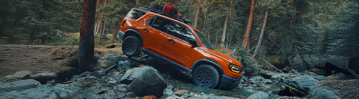 orange Honda Passport offroad