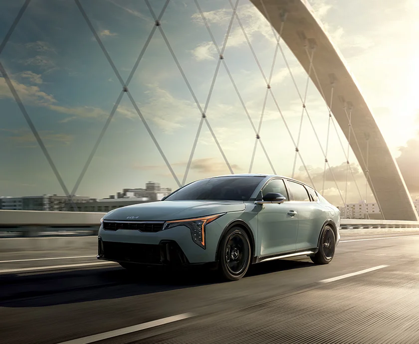 2026 Kia K4 crossing a bridge