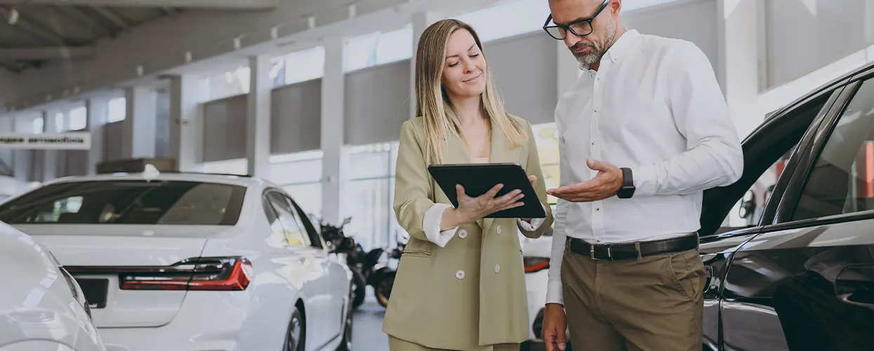 people talking in car showroom