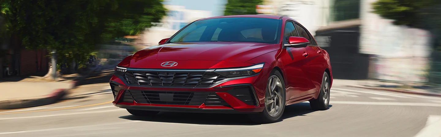 2025 Hyundai Elantra vs Toyota Corolla red color stand on city