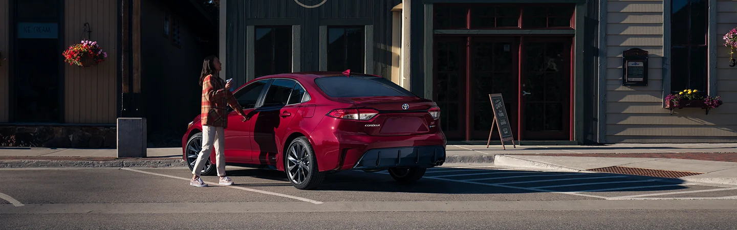 2025 Toyota Camry vs 2025 Toyota Corolla Red color Back view