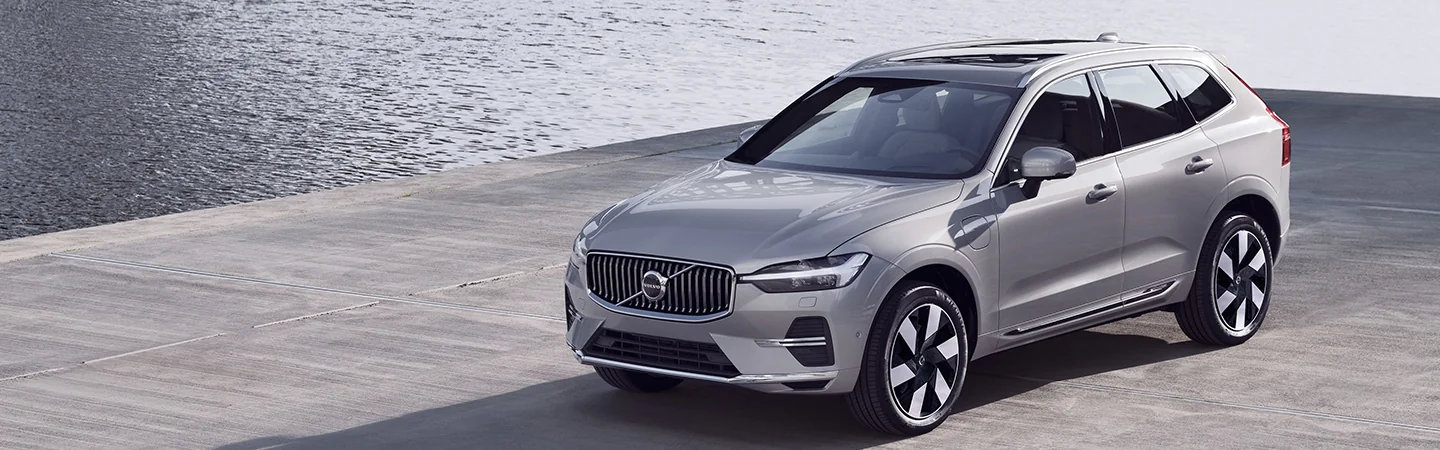 The 2025 Volvo XC60 Plug-in Hybrid light silver color car stand on road