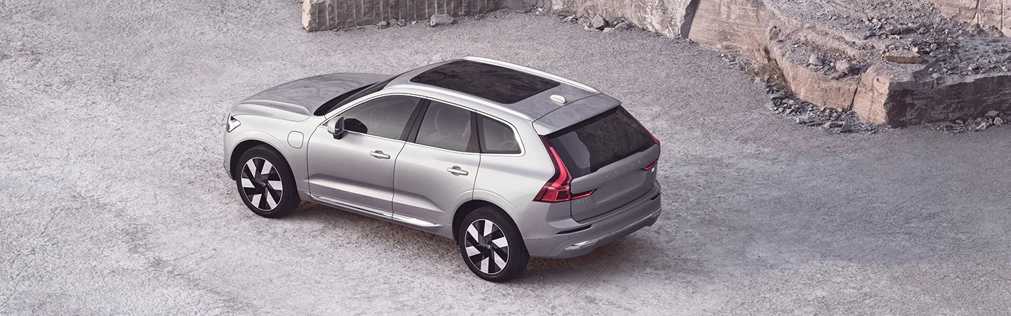 The 2025 Volvo XC60 Plug-in Hybrid light silver color car stand on road
