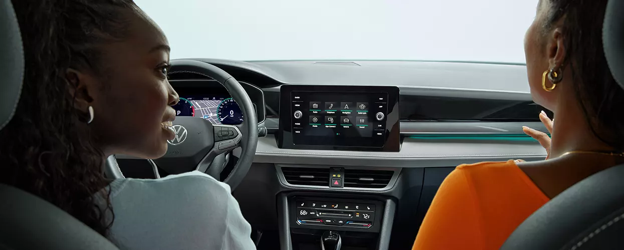 Two people sitting in a new Volkswagen