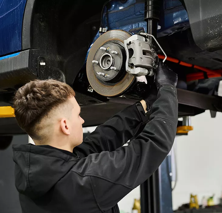 Technician servicing a vehicle