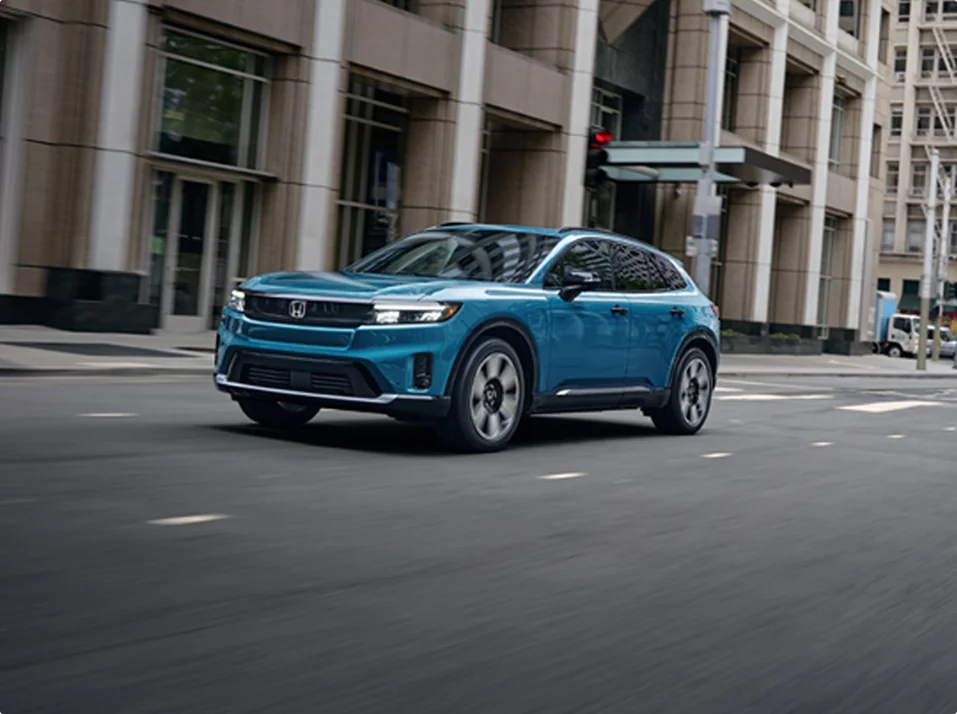 Blue Honda SUV driving in the city