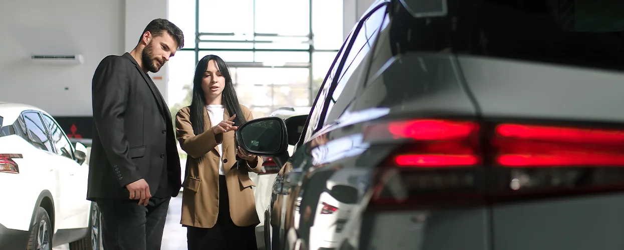 Sales person talking to customer about there new EV cars