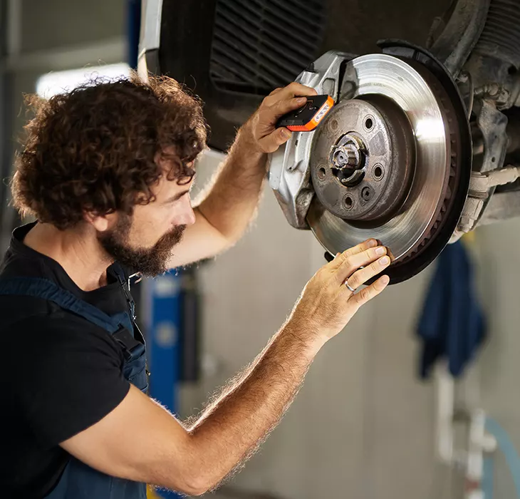 Technician servicing a vehicle