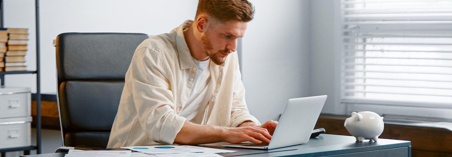 man typing on notebook computer