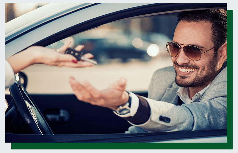 guy smiling being handed keys