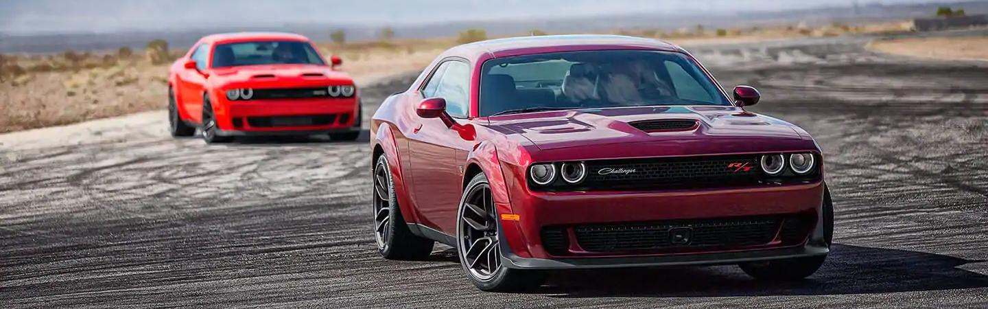 Two red Hellcats parked