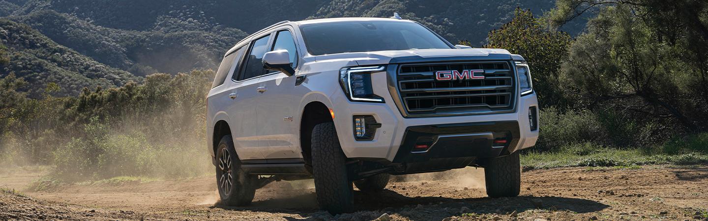 White 2022 GMC Yukon driving off road