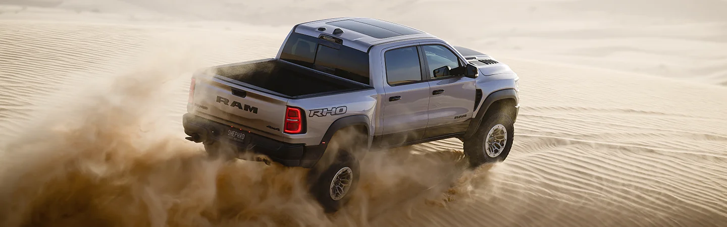 gray 2025 RAM 1500 driving in desert