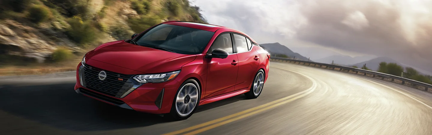 The 2025 Nissan Sentra in St. Petersburg, FL red color car on a road