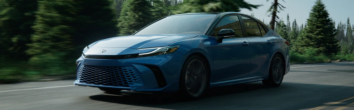 2025 Toyota Camry vs Toyota Corolla skyblue color car stand on road