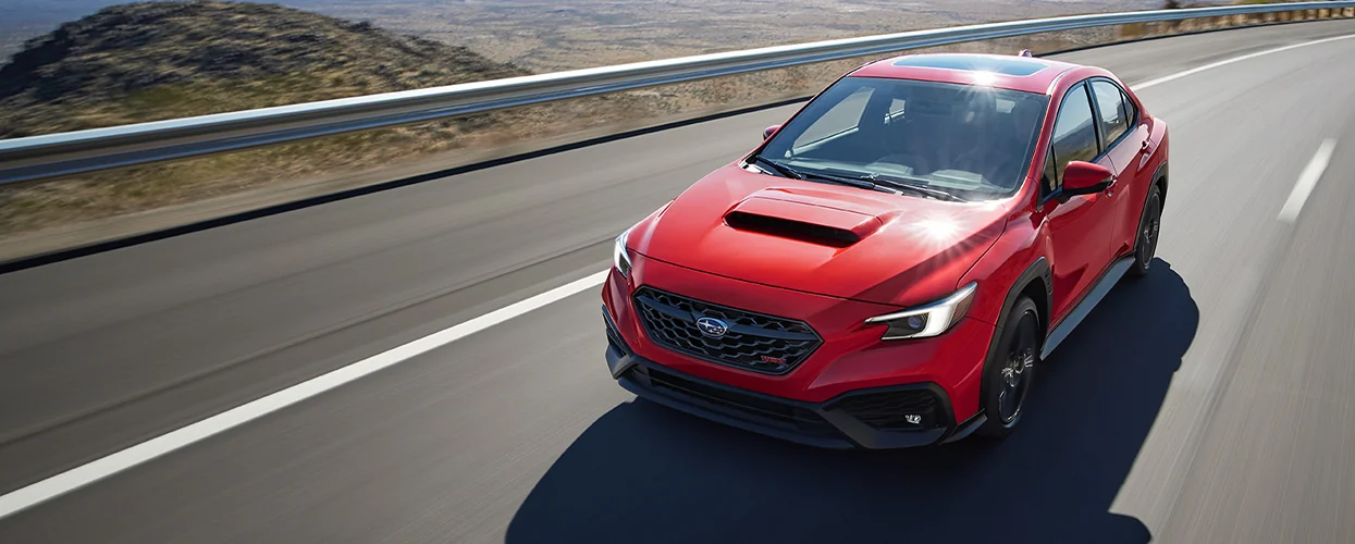 front view of a red 2026 Subaru WRX in motion