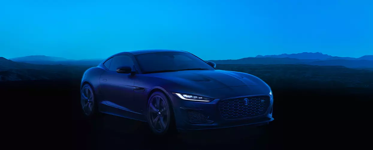 Jaguar F-Type driving at night down a road