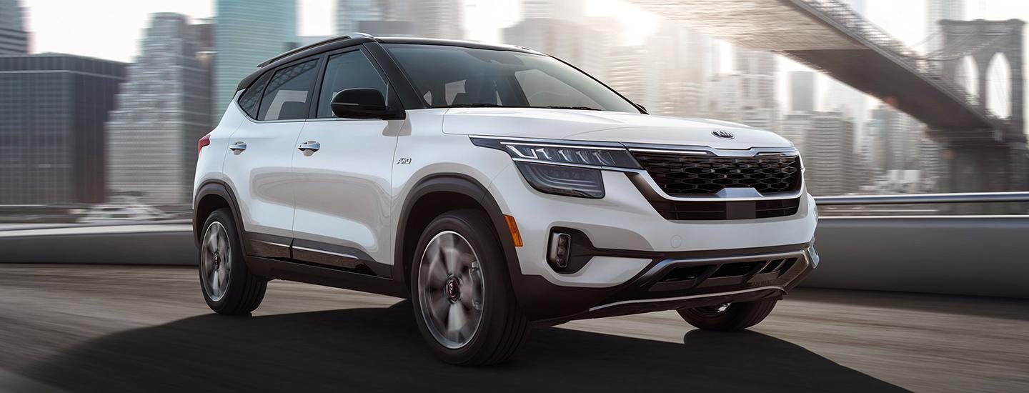 White Seltos in motion on a bridge