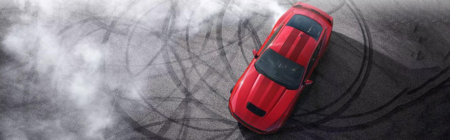 2024 Ford Mustang burning donuts in parking lot
