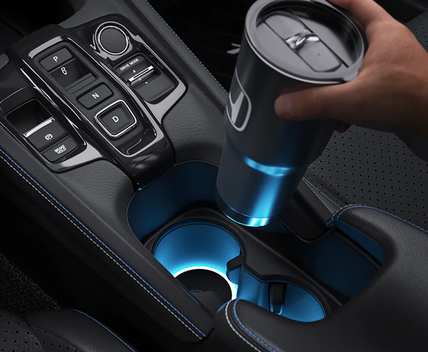 Interior view of the center console of a 2026 Honda Prelude where a person is putting a cup in the cup holder