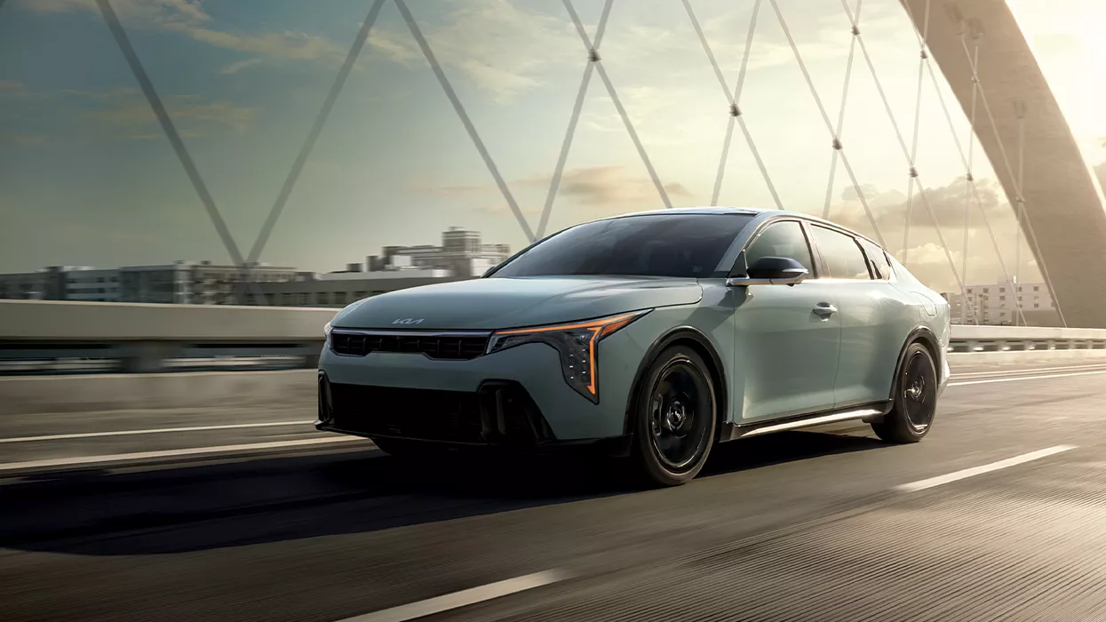 2026 Kia K4 driving on a bridge