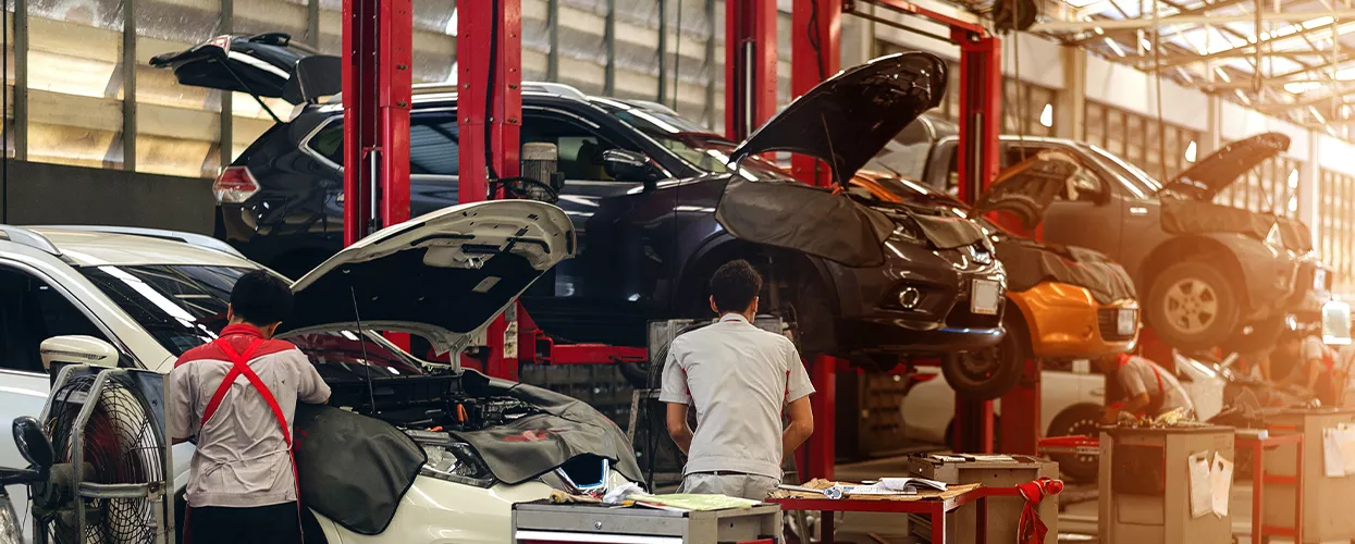 Service mechanics working on a row of vehicles