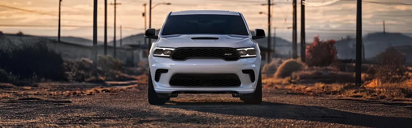 Front view of a white 2025 Dodge Durango parked in the desert