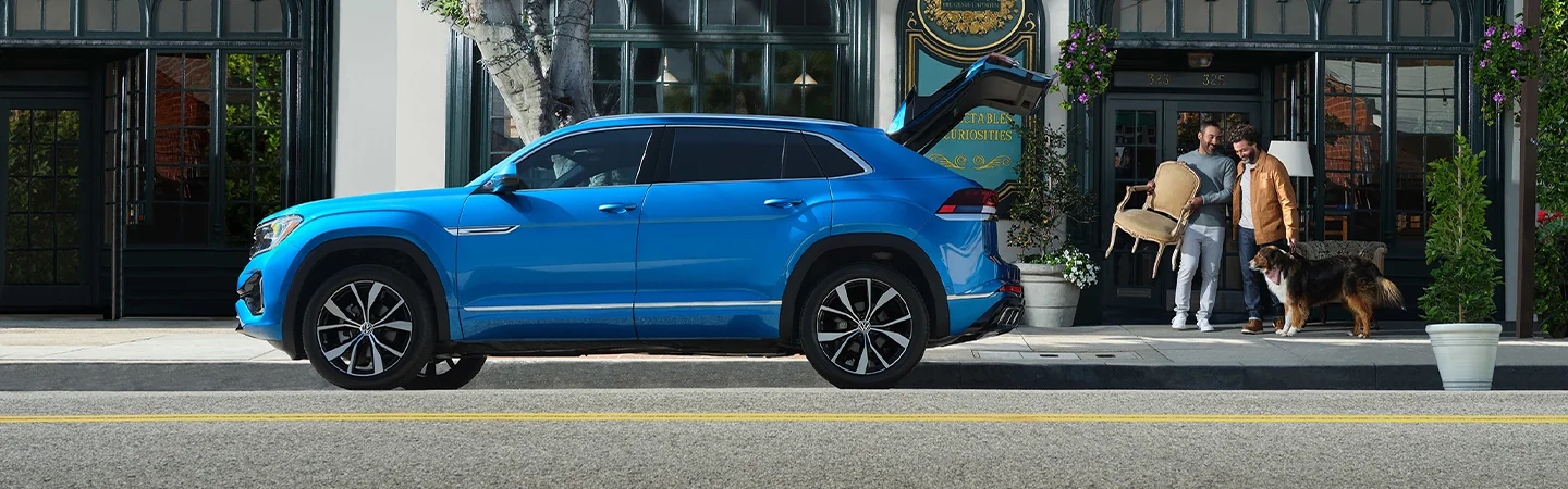 2025 Volkswagen Atlas Cross Sport SE being loaded with a chair and a dog