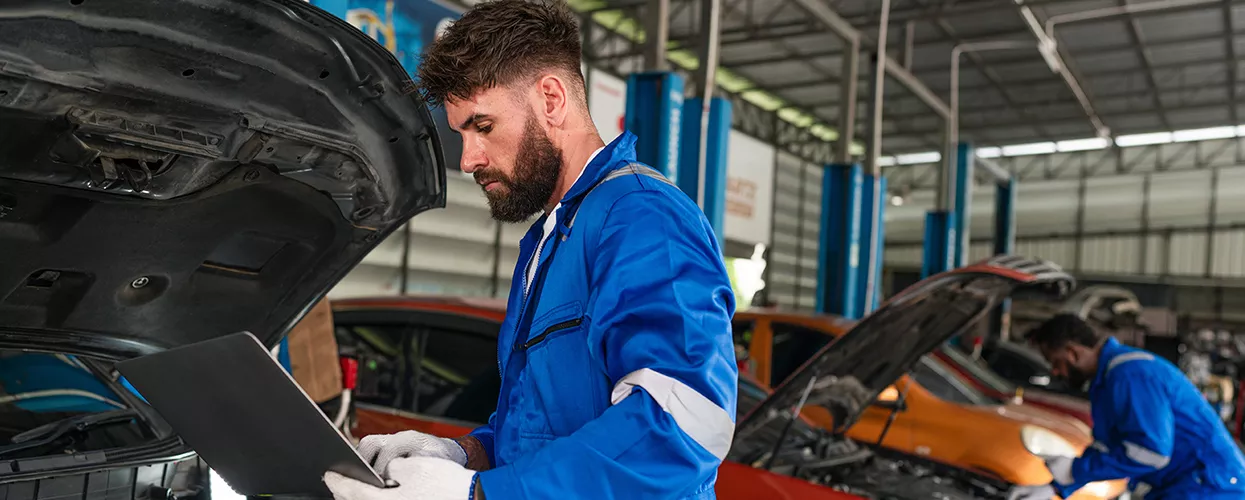 auto mechamic working on car in service bay