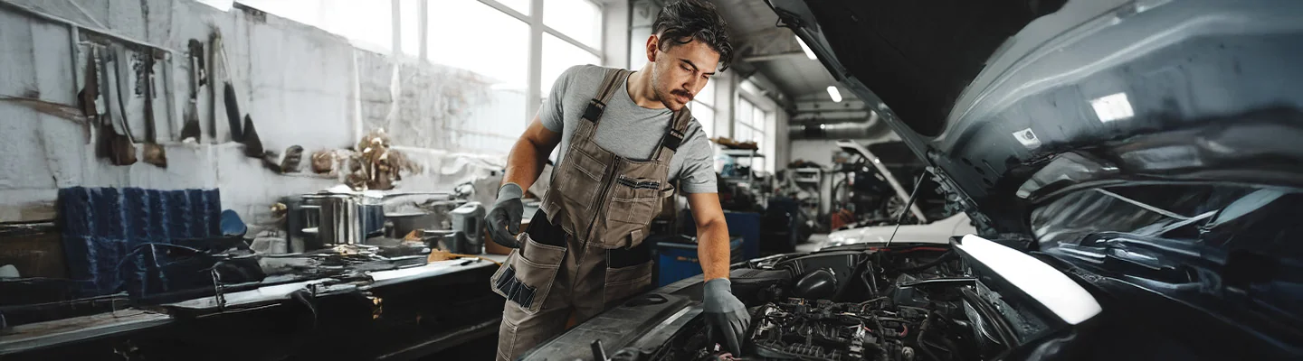 mechanic working on car engine