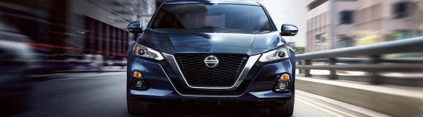 Blue Nissan Alitma Driving Forward