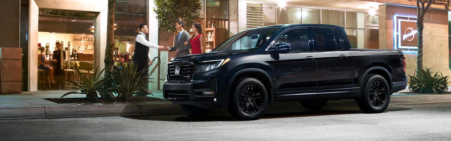 black 2022 Honda Ridgeline man and woman getting valet