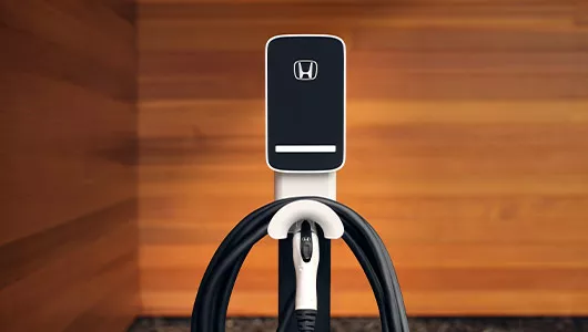 Honda home EV charging station wall unit with charging cable mounted on wall
