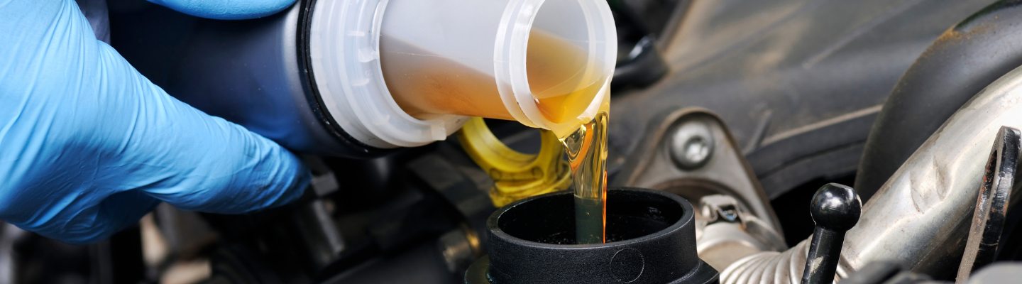Oil being poured slowly for an oil change
