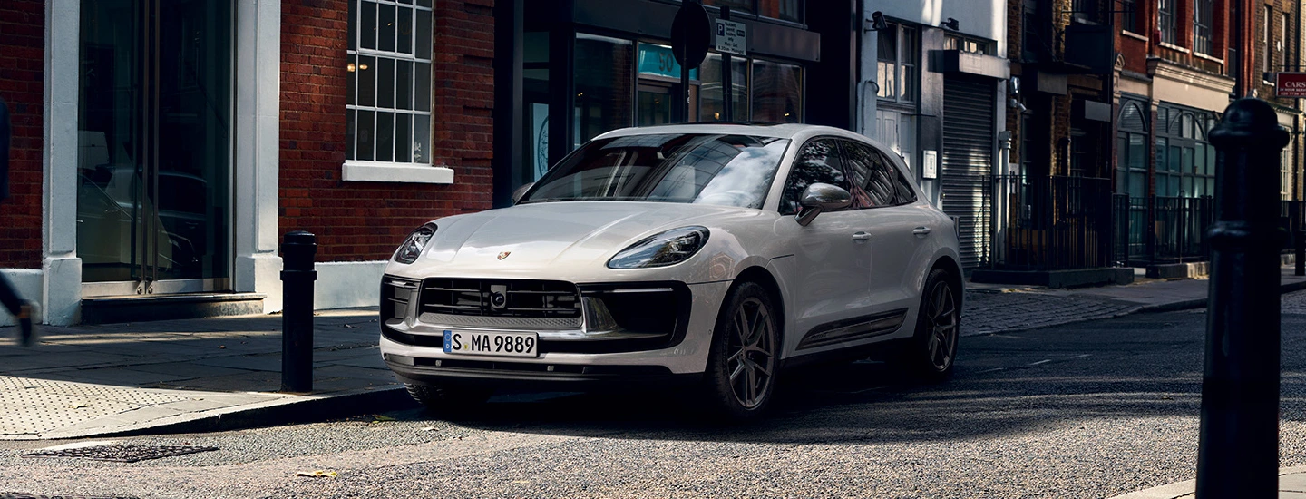 : 2024 Porsche Macan EV vs Tesla Model Y front side red 